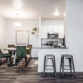 a kitchen with a table and chairs